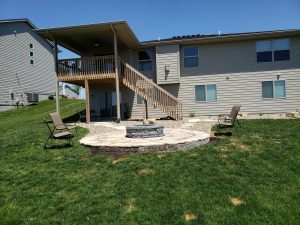 Backyard Makeover with Fire Pit Large Multi Level Retaining Wall by Norwalk Seasonal - Des Moines, Iowa