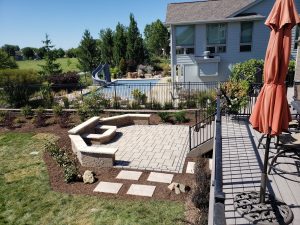 Large Stone Patio ad Fire Pit Large Multi Level Retaining Wall by Norwalk Seasonal - Des Moines, Iowa
