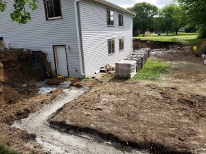 Before Large Retaining Wall Install Large Multi Level Retaining Wall by Norwalk Seasonal - Des Moines, Iowa