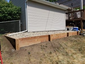 Small wooden retaining wall by Norwalk Seasonal - Des Moines, Iowa