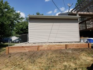 Small wooden retaining wall by Norwalk Seasonal - Des Moines, Iowa