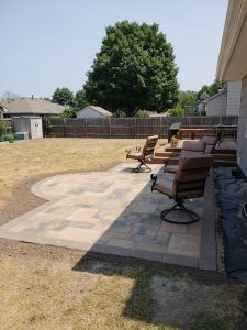 stonework backyard patio by Norwalk Seasonal - Des Moines, Iowa