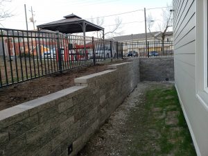 Large stone commercial retaining wall by Norwalk Seasonal - Des Moines, Iowa