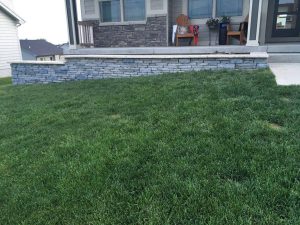 Stone and brick retaining wall by Norwalk Seasonal - Des Moines, Iowa