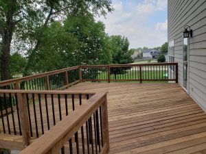 Large Second Level Cedar-toned green treated wood Deck Build by Norwalk Seasonal - Des Moines, Iowa