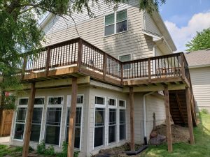 Large Cedar-toned Green treated lumber Deck Build by Norwalk Seasonal - Des Moines, Iowa