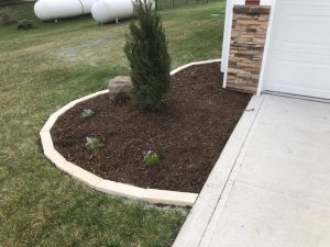 Front Yard Mulch Garden with limestone edging by Norwalk Seasonal - Des Moines, Iowa
