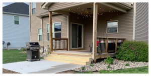 Cedar-toned New Deck and poured concrete Patio with a grill by Norwalk Seasonal - Des Moines, Iowa