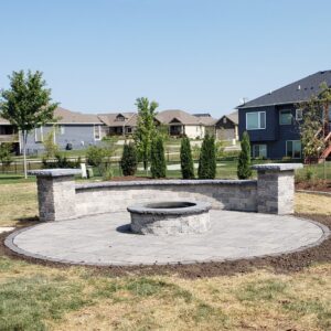 Unilock seat wall and tech-bloc paver patio landscape installation by Norwalk Seasonal - Des Moines, Iowa