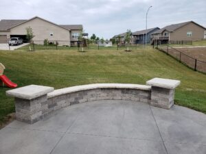Patio with small brick wall by Norwalk Seasonal - Des Moines, Iowa