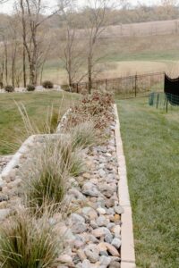 River Rock Landscaping with linestone edging a shrub Garden Norwalk Seasonal - Des Moines, Iowa