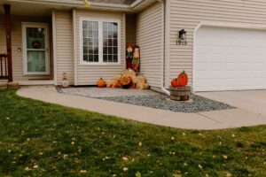 Front Porch with a Unilock Paver Patio next to a Rock Garden bed Norwalk Seasonal - Des Moines, Iowa