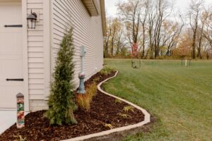 Mulch Garden and Plants along Garage Norwalk Seasonal - Des Moines, Iowa