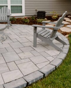 Beautiful Techp-Bloc Patio installed in Central Iowa by Norwalk Seasonal - Des Moines, Iowa This photo also features a flagstone pathway next to the home leading to the grey techo patio with grey Adirondack chairs